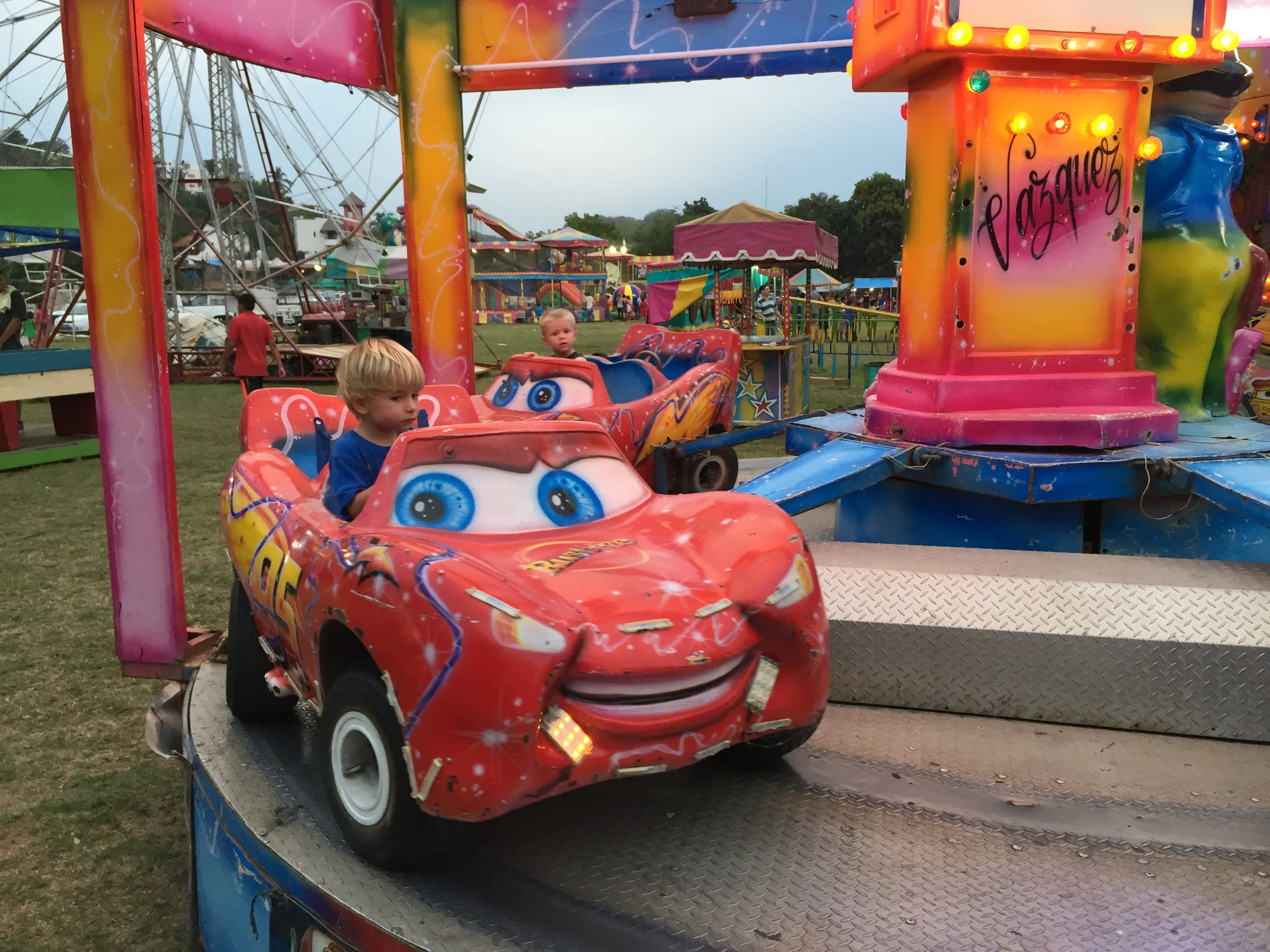 A red cartoon race-car ride at the town carnival